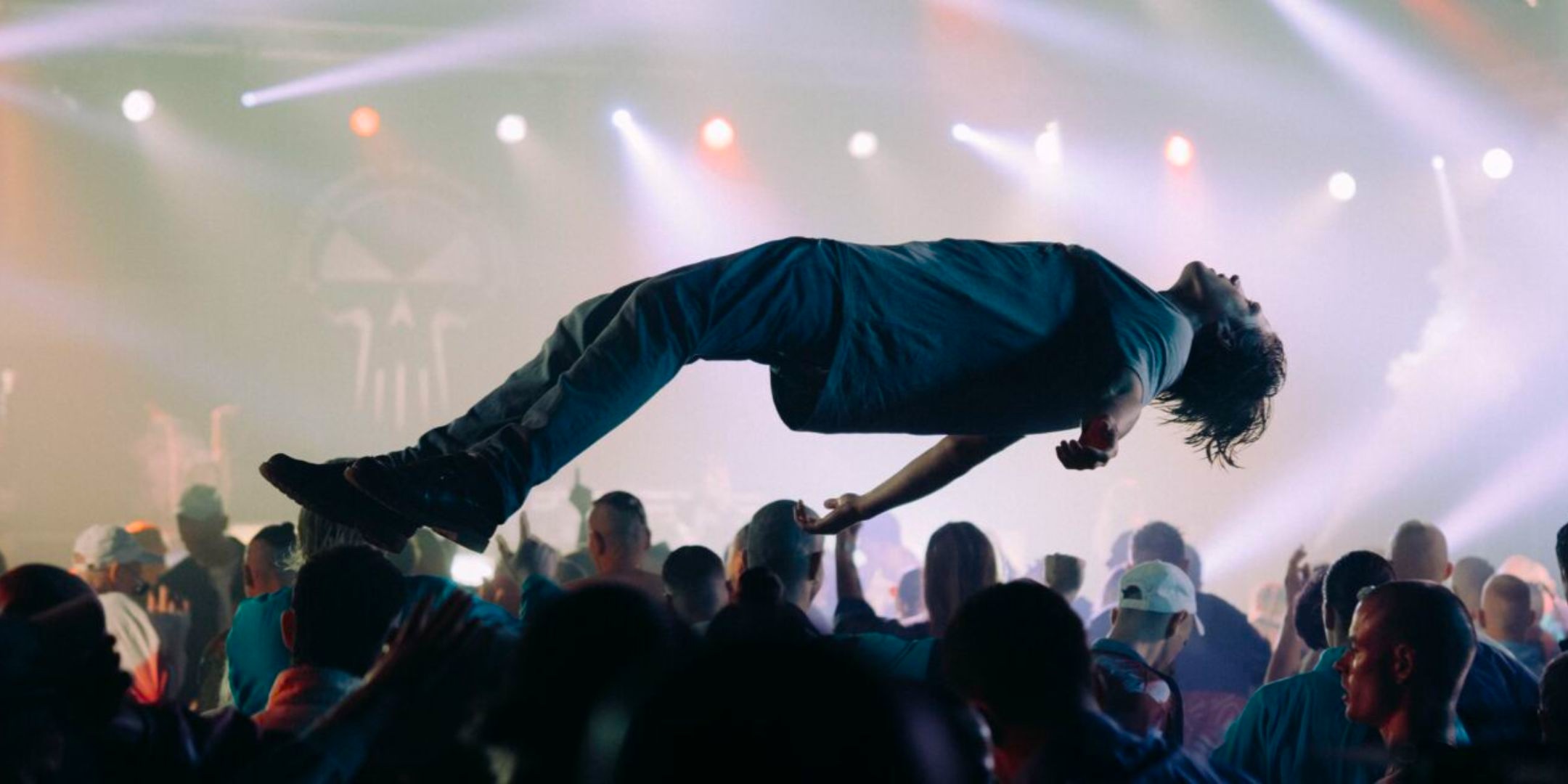 A crowd-surfer over a rave, lit by Exciting Light, in the feature film Hardcore Never Dies